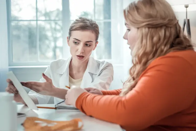 Overweight patient talking with doctor