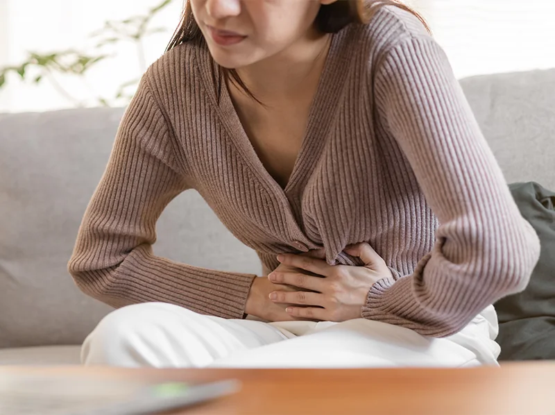 Woman holding abdomen in pain