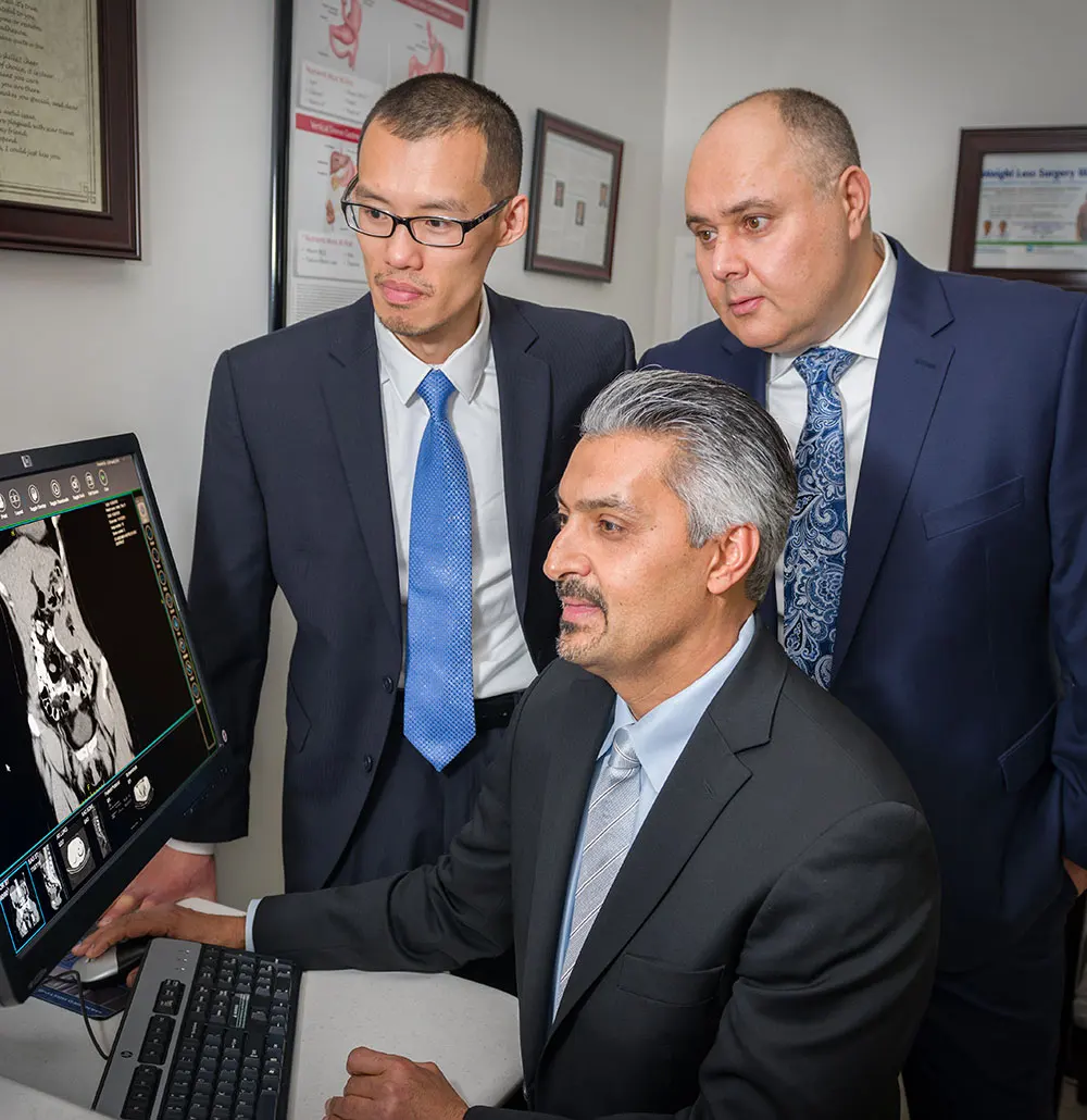 Doctors looking at digital image on screen