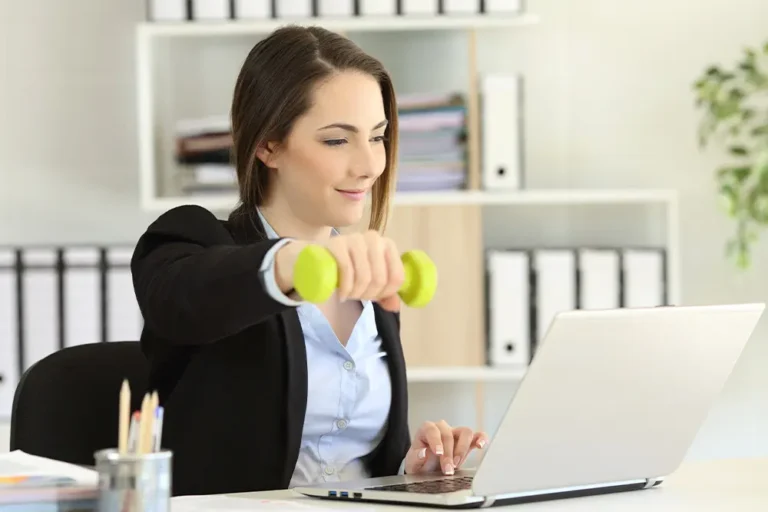 woman stretching arm at work