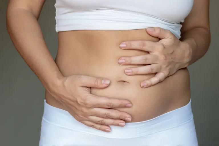 woman holding her abdomen in pain from hernia