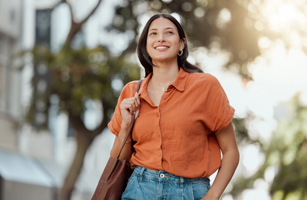 Woman smiling and walking outdoors after gallbladder removal surgery