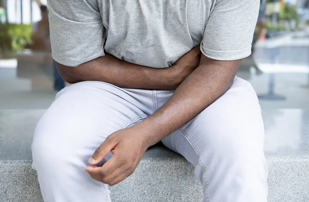 Man sitting down while having a hernia
