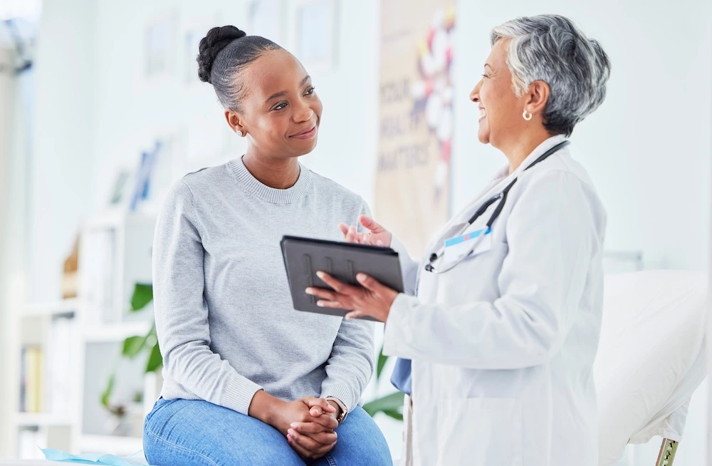 hopeful female patient consulting with bariatric doctor about revision surgery